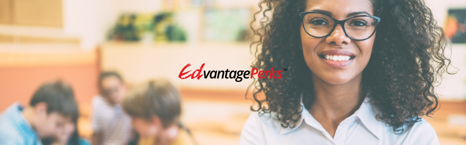 Black female teacher in the foreground with a group of students in the background. The Edvantage Perks logo is placed in the centre. 