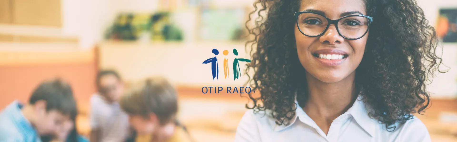 Black female teacher in the foreground with a group of students in the background. The OTIP logo is placed in the centre.