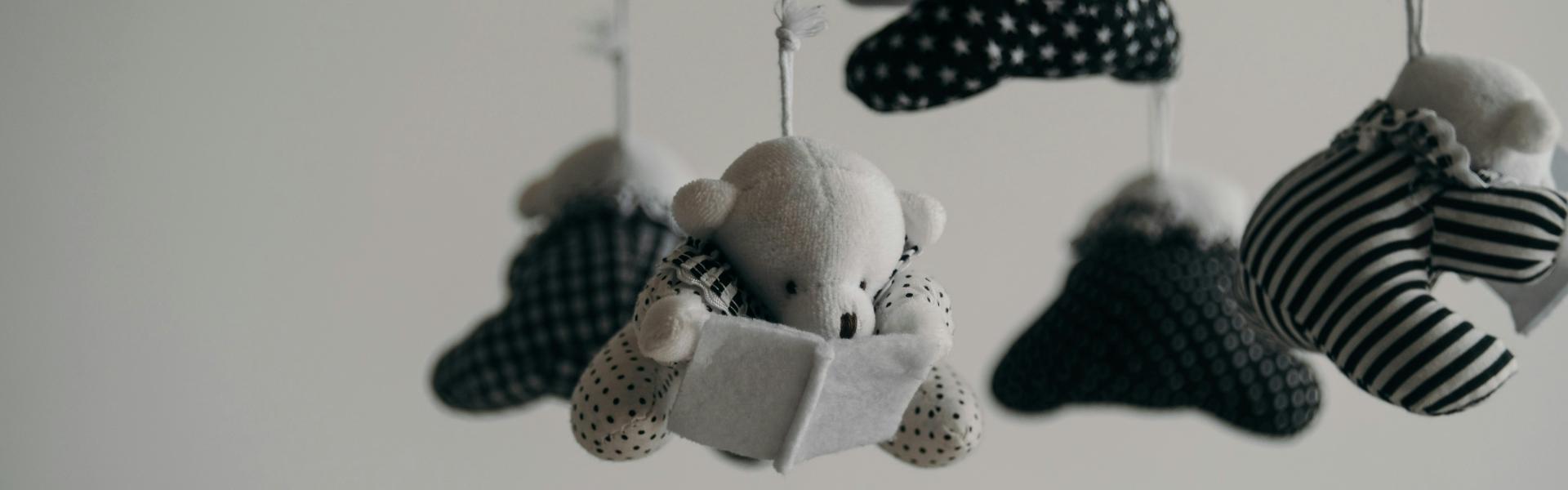 black and white baby mobile made of teddy bears