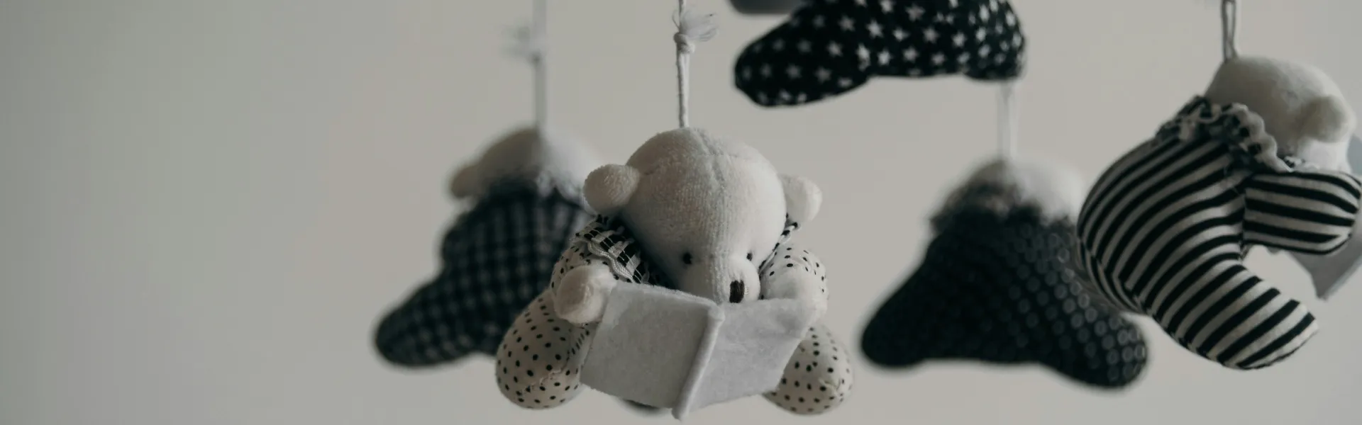 black and white baby mobile made of teddy bears